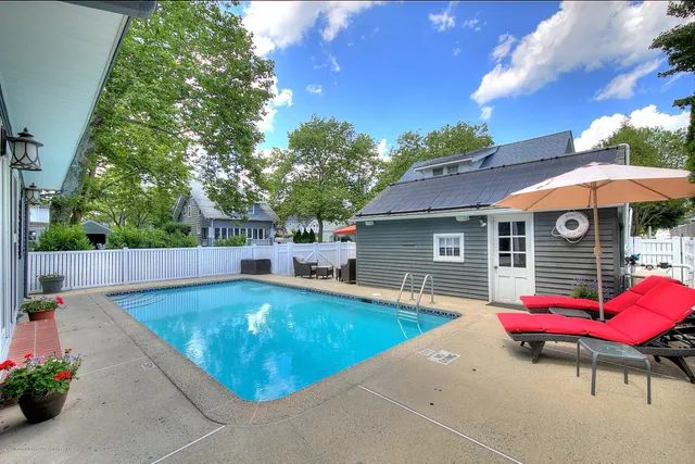a view of a backyard with a patio and fire pit
