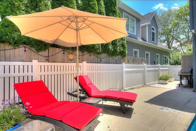 a view of a deck with a table and chairs under an umbrella