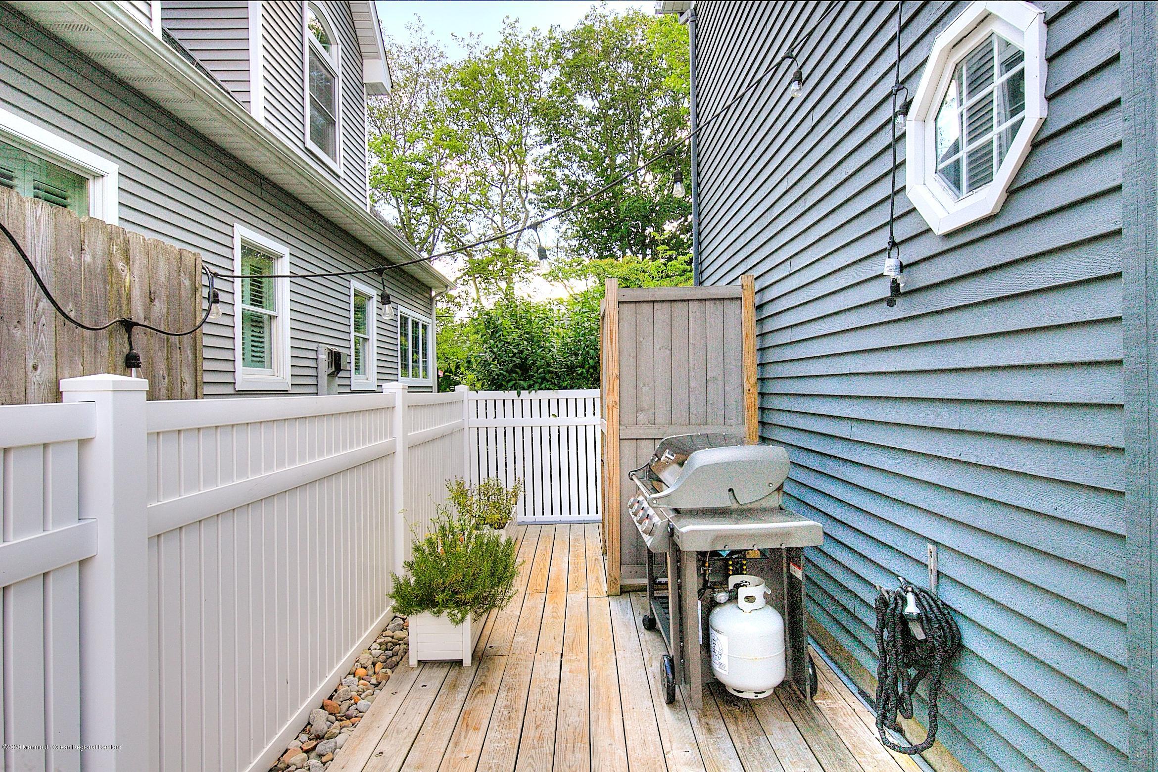 344 Euclid Avenue Manasquan, NJ 08736 - Photo 24 of 24 a view of a balcony with chairs and wooden floor