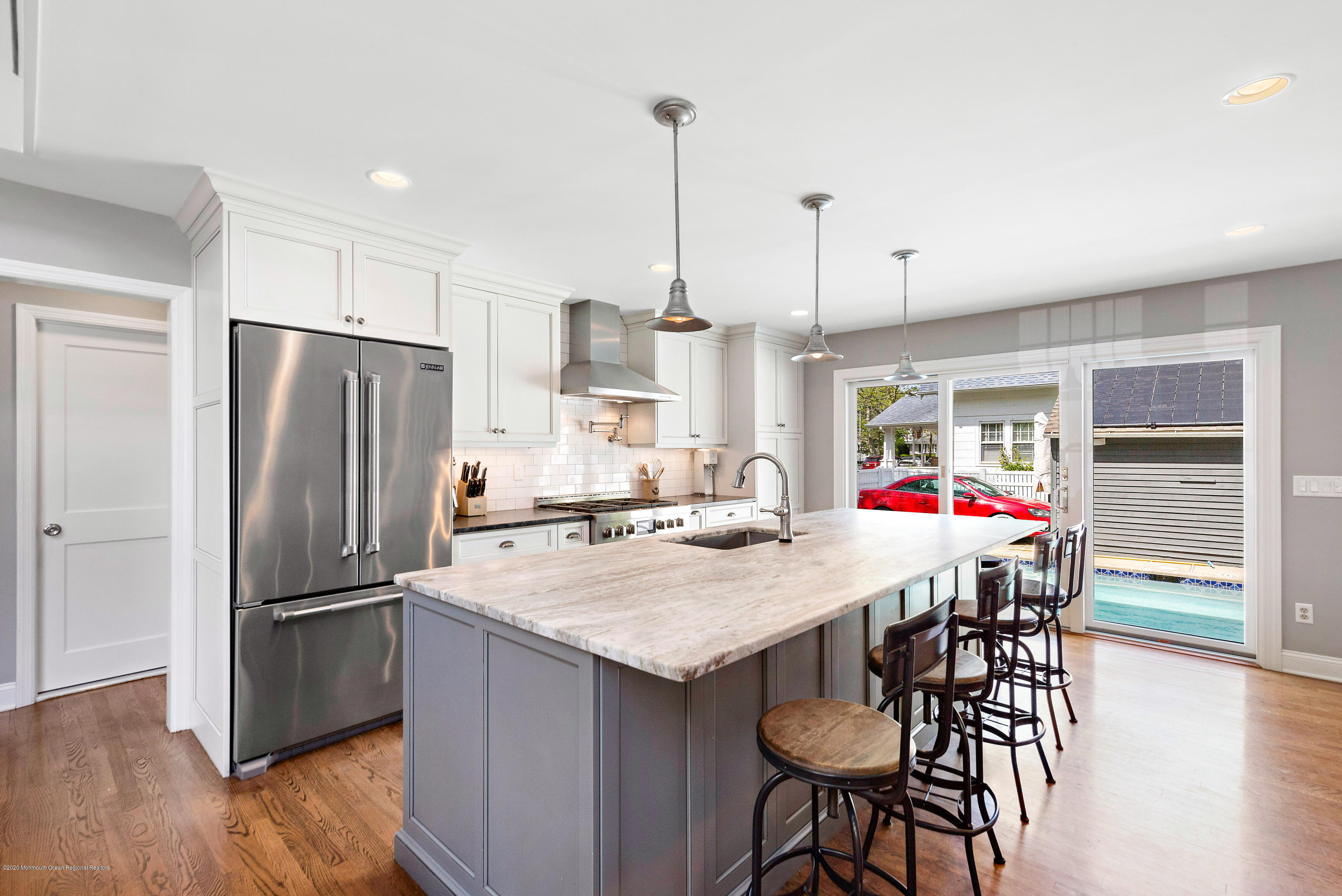 344 Euclid Avenue Manasquan, NJ 08736 - Photo 4 of 24 a kitchen with refrigerator cabinets dining table and chairs