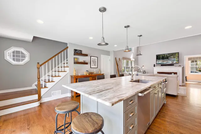 a kitchen with sink stove and wooden floor
