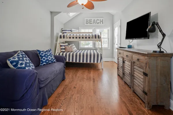 a bedroom with furniture and a flat screen tv