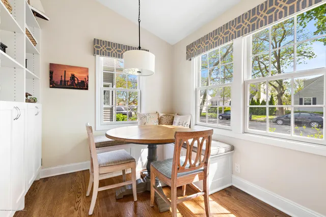 a view of a dining room with furniture wooden floor and a chandelier