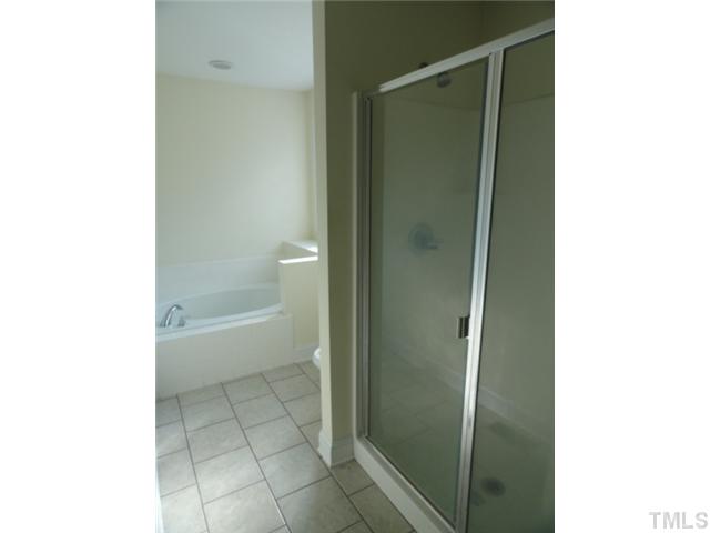 14 Lewis Road Zebulon, NC 27597 - Photo 8 of 12 a bathroom with a shower and a toilet