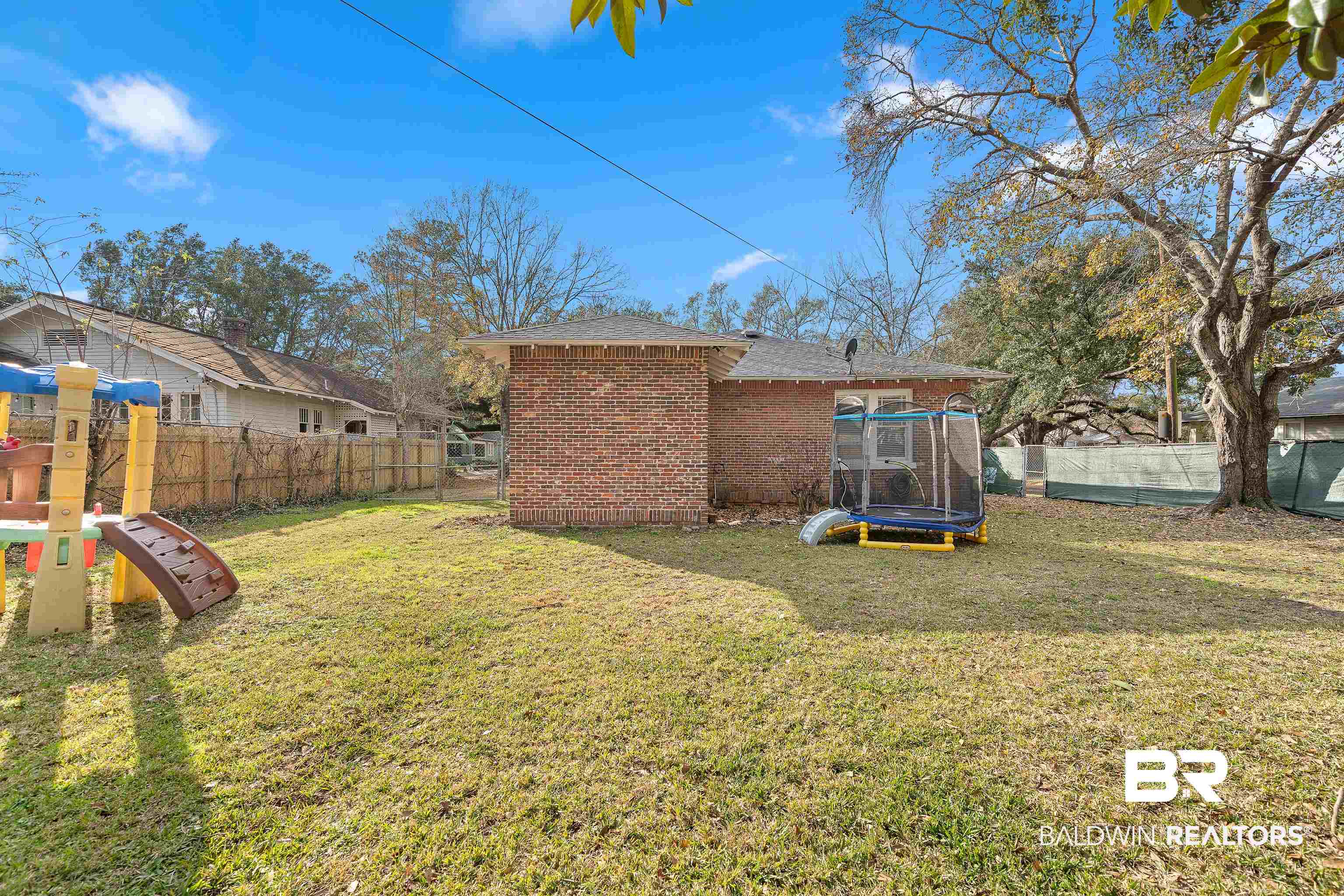 111 Macy Place Mobile, AL 36604 - Photo 31 of 35 View of yard with a playground and a trampoline