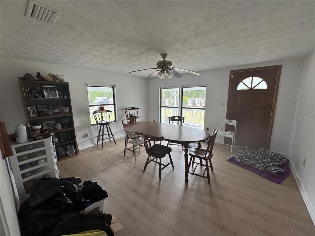 5515 Shad Road Jacksonville, FL 32257 - Photo 10 of 16 a view of a dining room with furniture and wooden floor