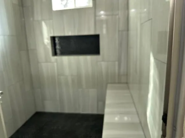 a bathroom with a shower and a sink