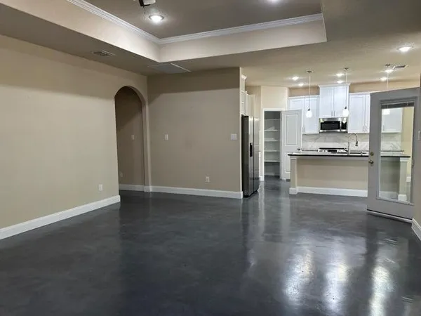 a view of kitchen with stainless steel appliances granite countertop a refrigerator and a stove top oven