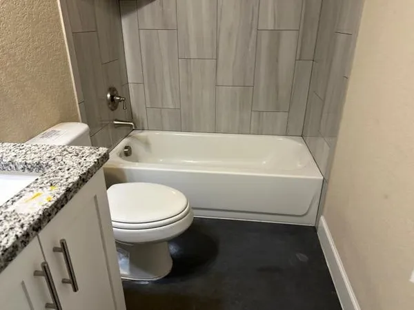 a bathroom with a sink a toilet and bathtub