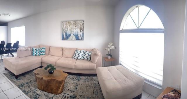 16654 Southwest 103rd Lane Miami, FL 33196 - Photo 2 of 20 a living room with furniture and a window