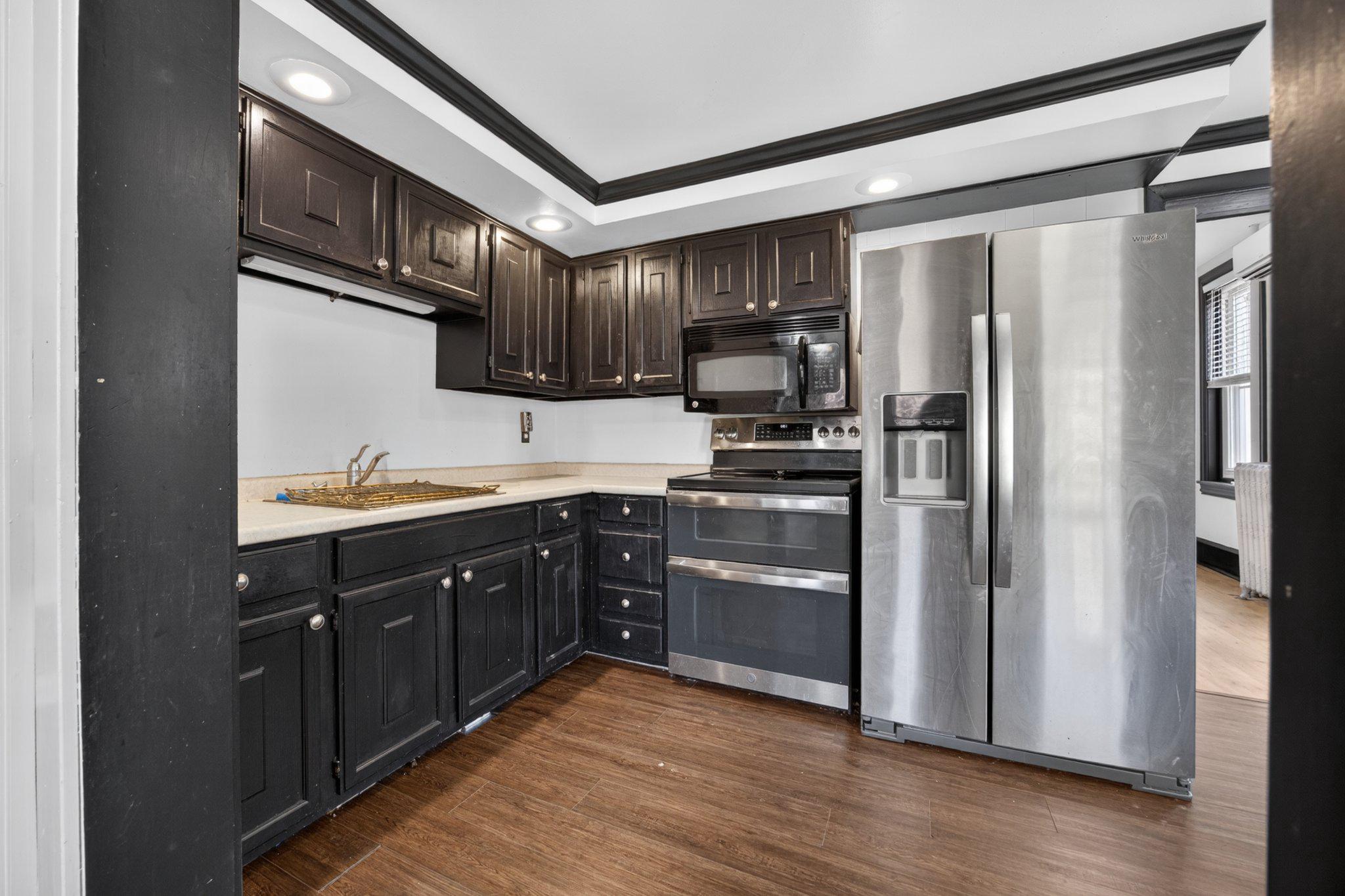 321 Walnut Street Spring City, PA 19475 - Photo 11 of 30 Sleek modern kitchen with dark cabinetry.