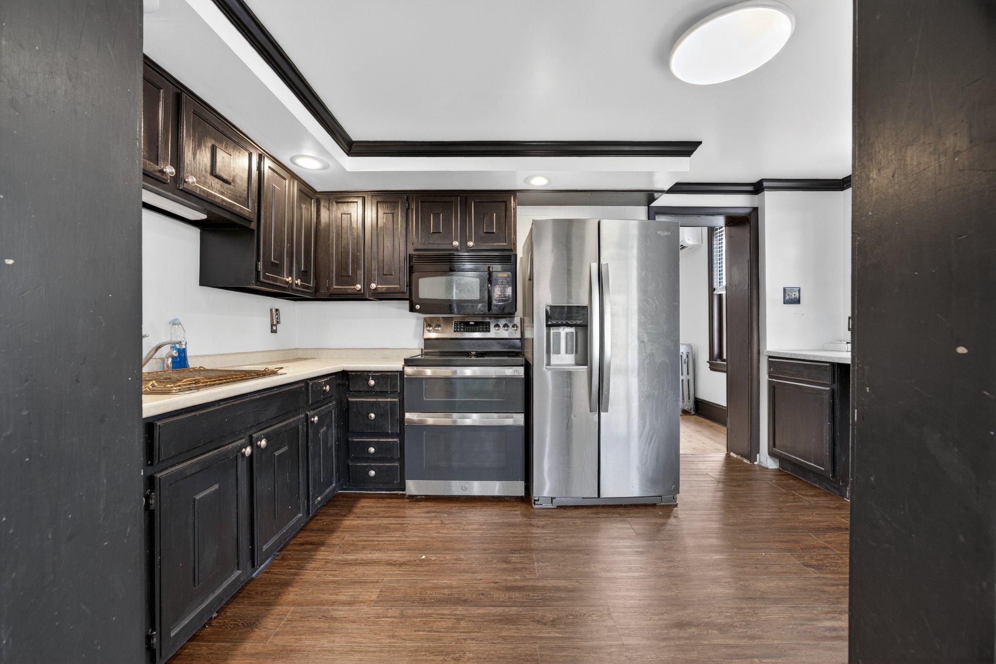 321 Walnut Street Spring City, PA 19475 - Photo 12 of 30 Sleek modern kitchen with dark cabinetry.