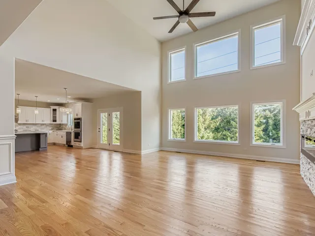 a view of empty room with wooden floor and fireplace