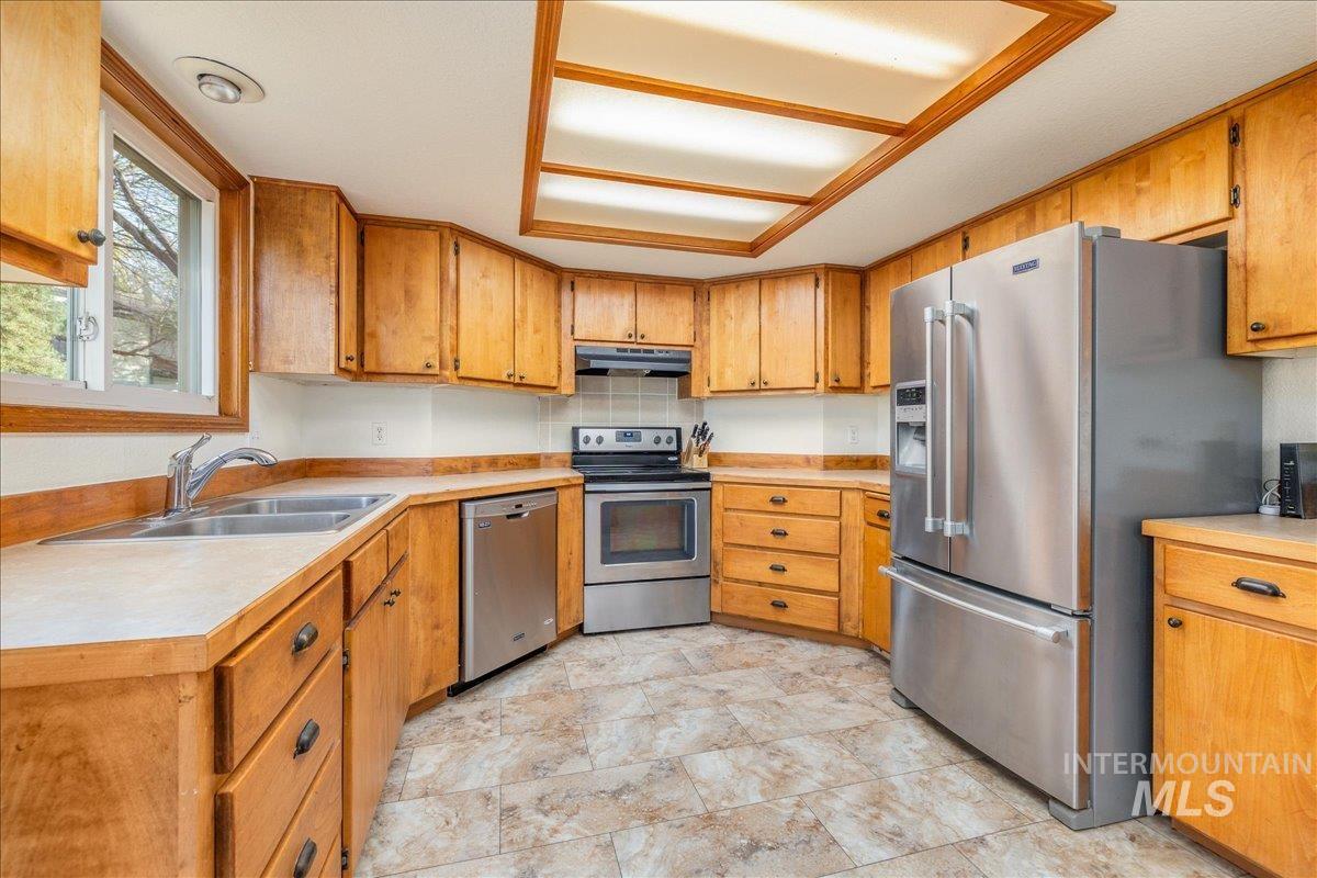 236 East Bayview Court Boise, ID 83706 - Photo 14 of 49 Kitchen with stainless steel appliances, light countertops, and wood finish cabinetry