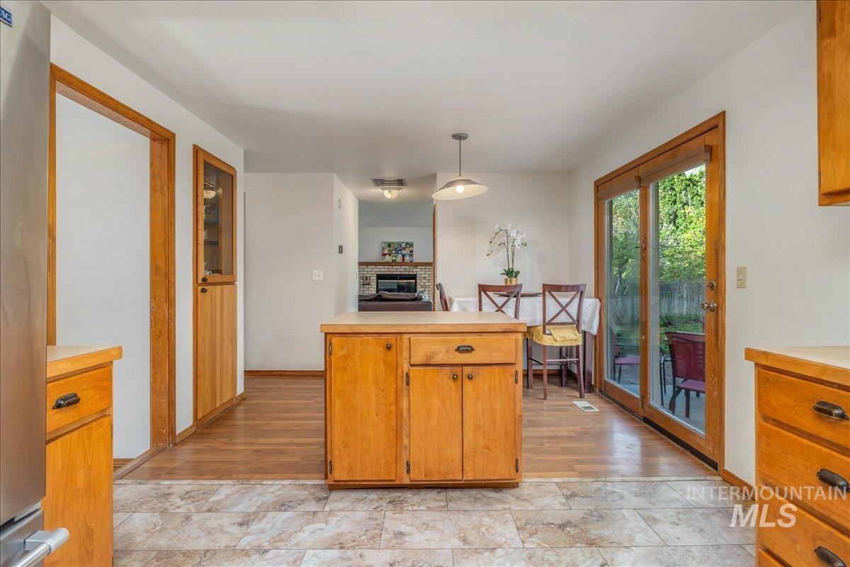 236 East Bayview Court Boise, ID 83706 - Photo 17 of 49 Kitchen featuring light countertops, pendant lighting, stainless steel refrigerator, and wood finish cabinetry