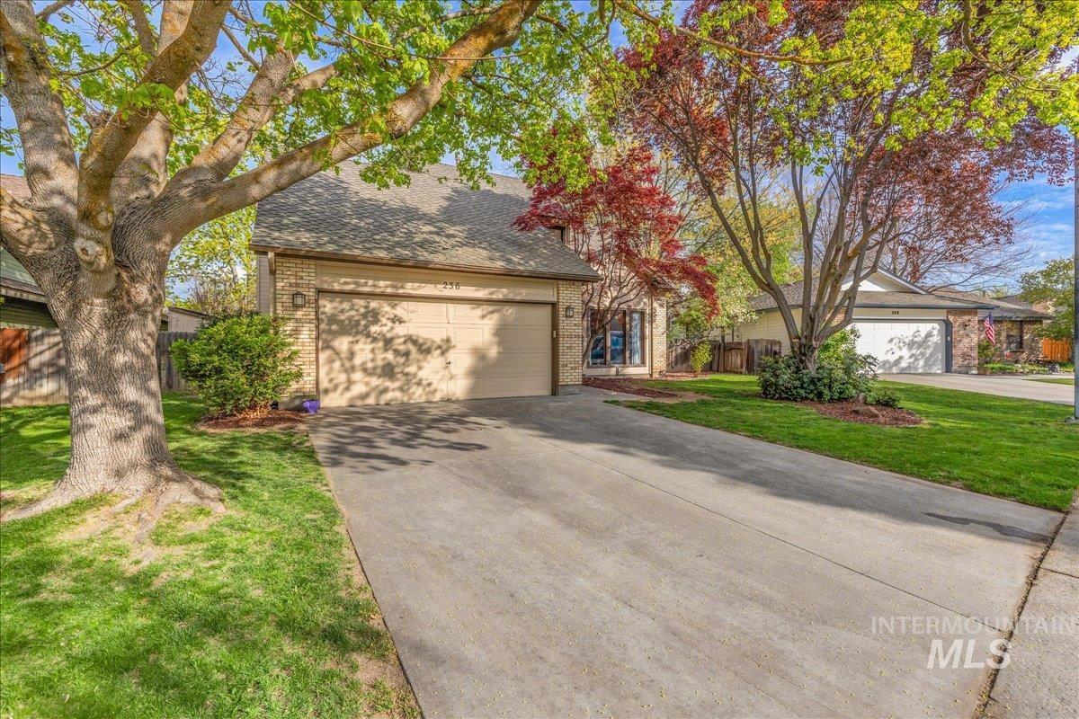 236 East Bayview Court Boise, ID 83706 - Photo 2 of 49 View of front of property with brick siding, roof with shingles, concrete driveway, and a garage