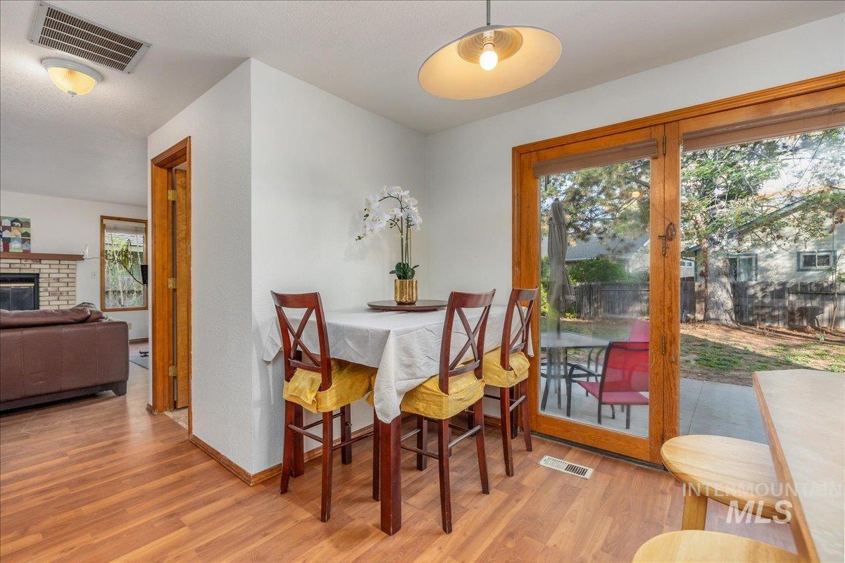 236 East Bayview Court Boise, ID 83706 - Photo 22 of 49 Dining space with light wood-style flooring and a brick fireplace