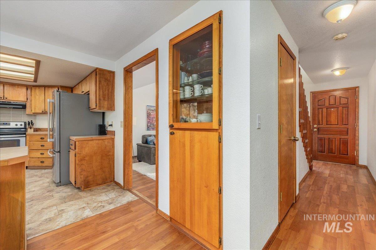 236 East Bayview Court Boise, ID 83706 - Photo 23 of 49 Kitchen with stainless steel appliances, light countertops, light wood-style floors, and wood finish cabinetry