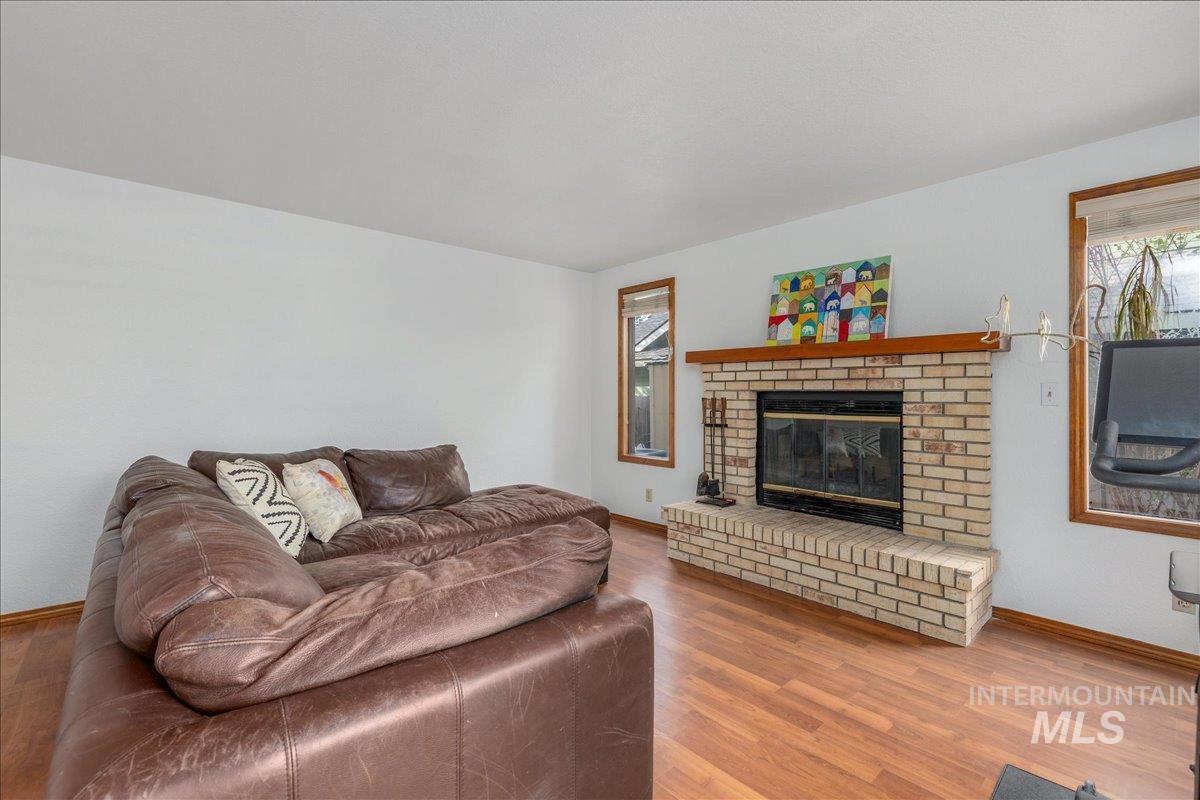 236 East Bayview Court Boise, ID 83706 - Photo 24 of 49 Living area featuring healthy amount of natural light, wood finished floors, and a fireplace