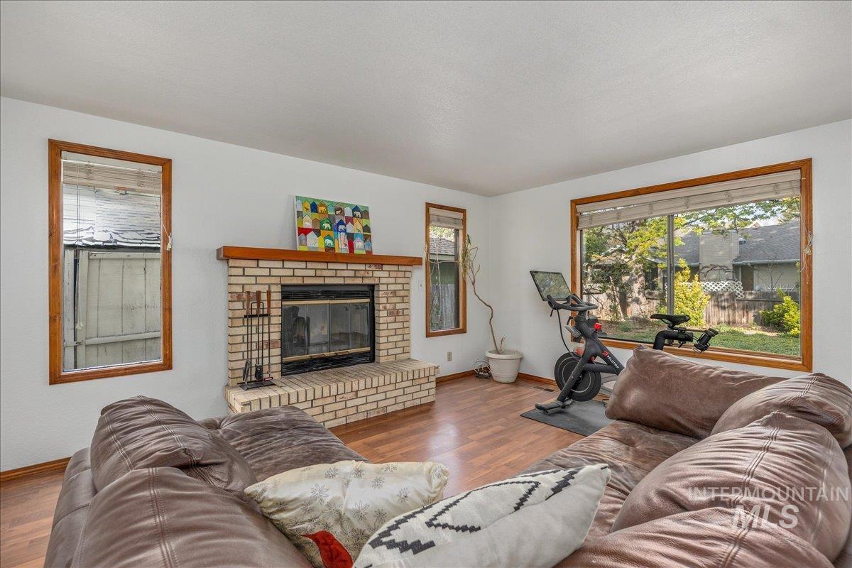 236 East Bayview Court Boise, ID 83706 - Photo 26 of 49 Living area featuring wood finished floors and a brick fireplace