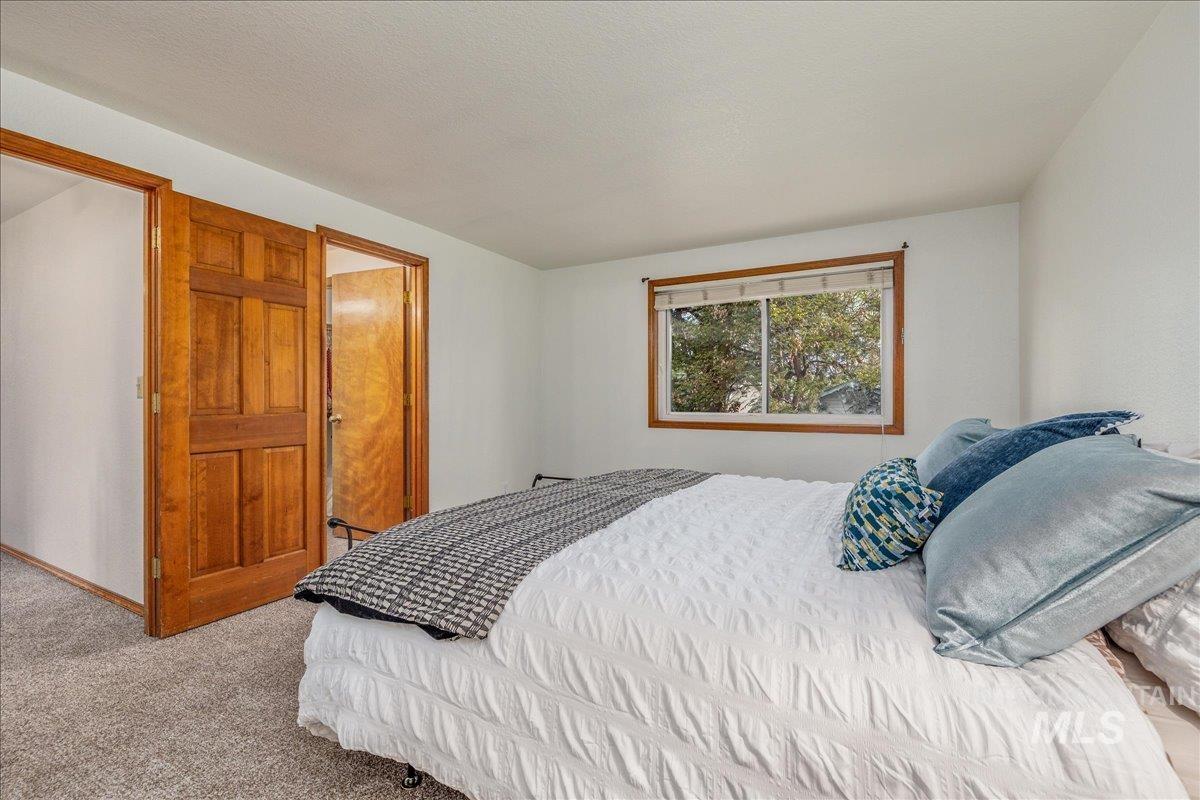 236 East Bayview Court Boise, ID 83706 - Photo 28 of 49 Bedroom with light carpet and baseboards
