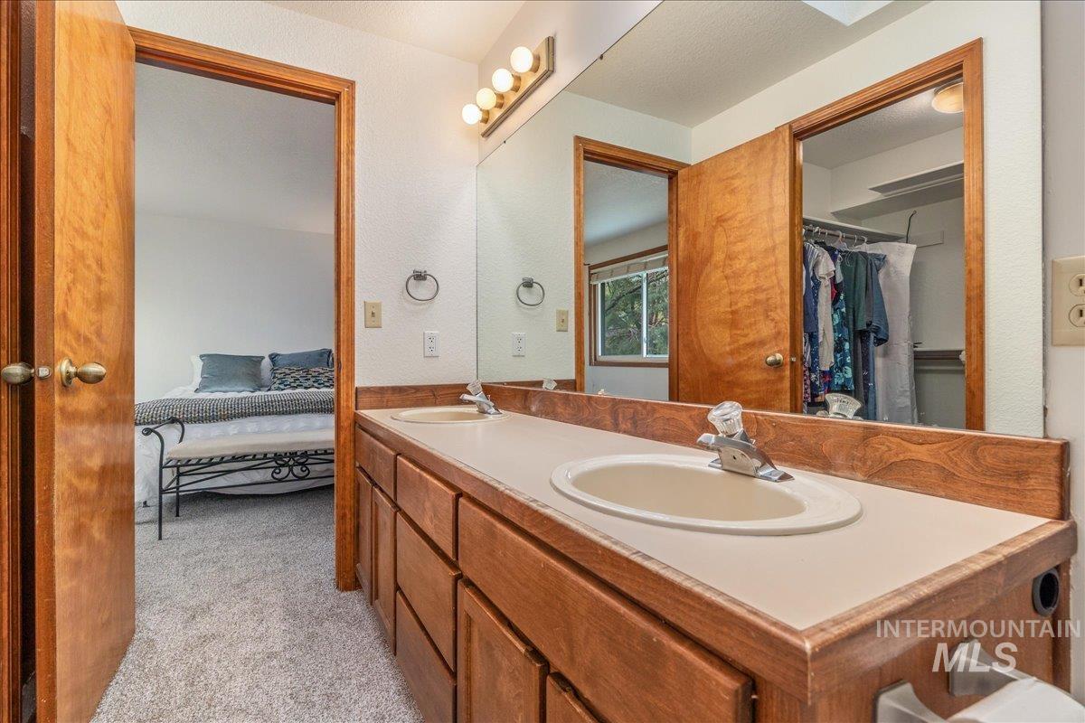 236 East Bayview Court Boise, ID 83706 - Photo 30 of 49 Full bathroom featuring ensuite bath, double vanity, light carpet, and a spacious closet