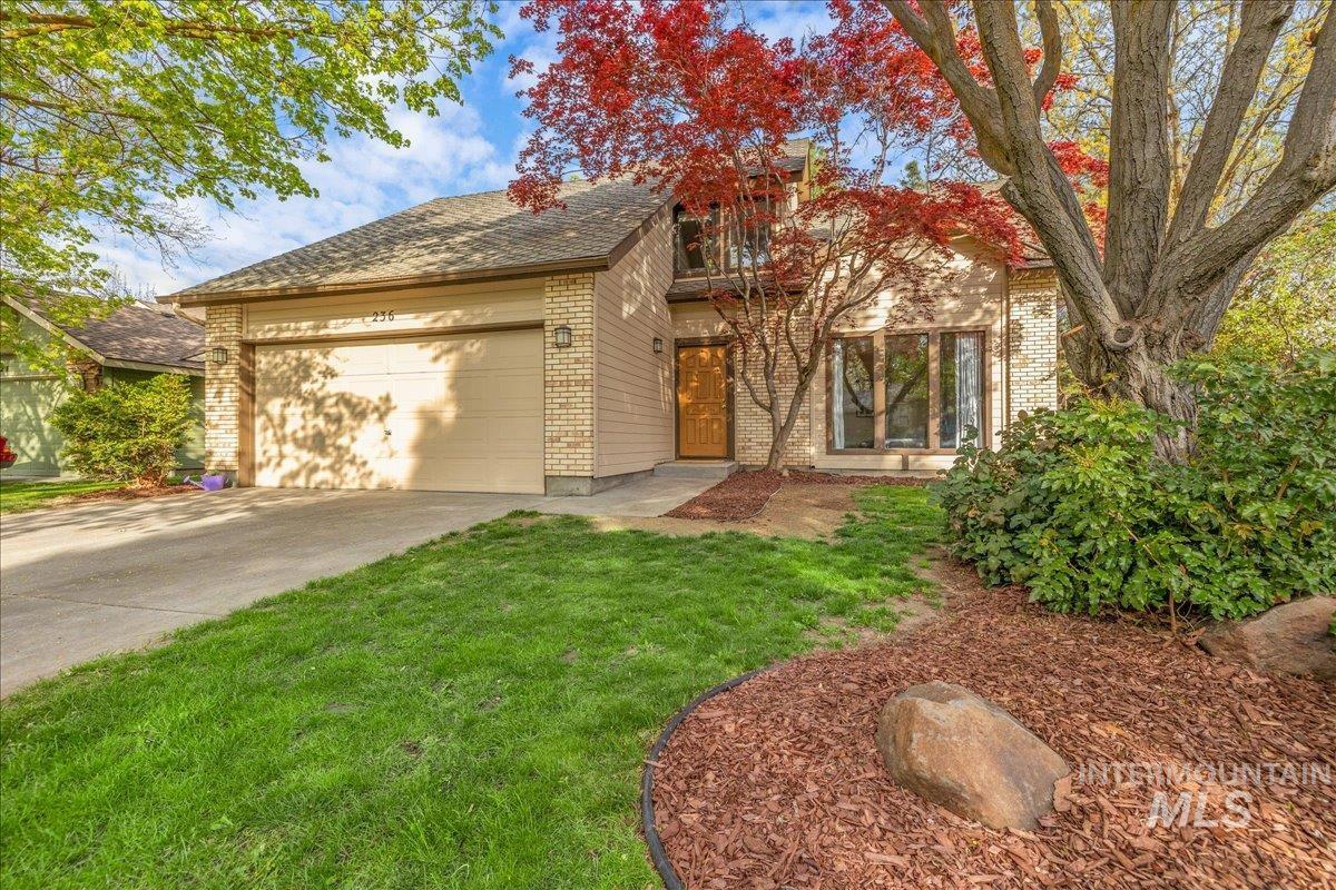 236 East Bayview Court Boise, ID 83706 - Photo 3 of 49 View of front facade with brick siding, an attached garage, concrete driveway, and a front lawn