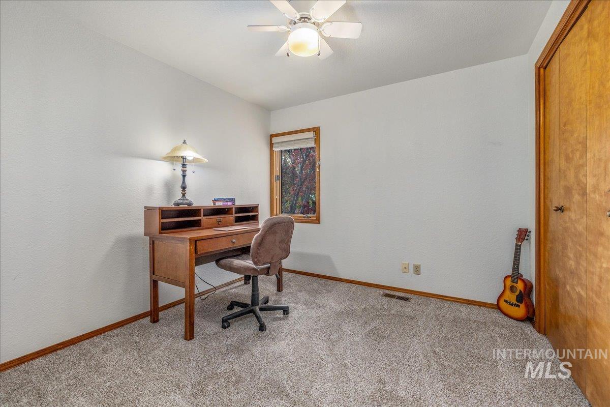 236 East Bayview Court Boise, ID 83706 - Photo 33 of 49 Office area featuring ceiling fan, light carpet, and a textured wall