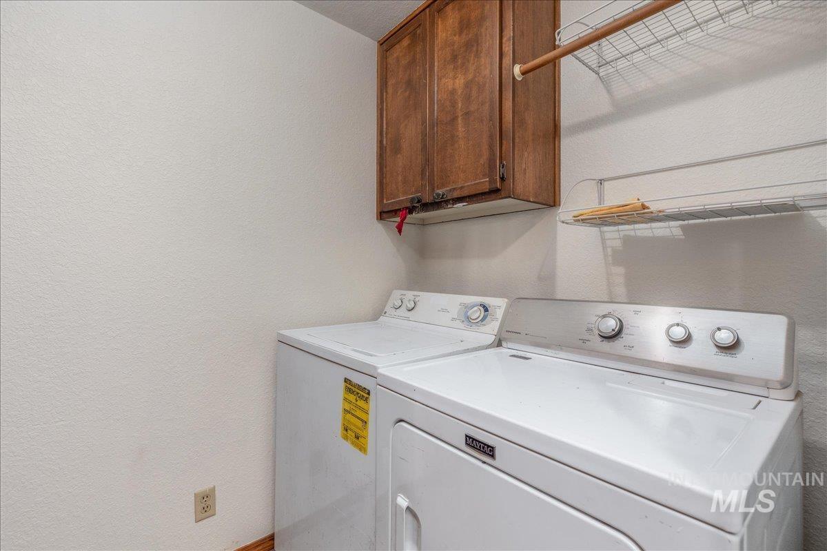 236 East Bayview Court Boise, ID 83706 - Photo 39 of 49 Laundry area featuring a textured wall, cabinet space, and washing machine and dryer
