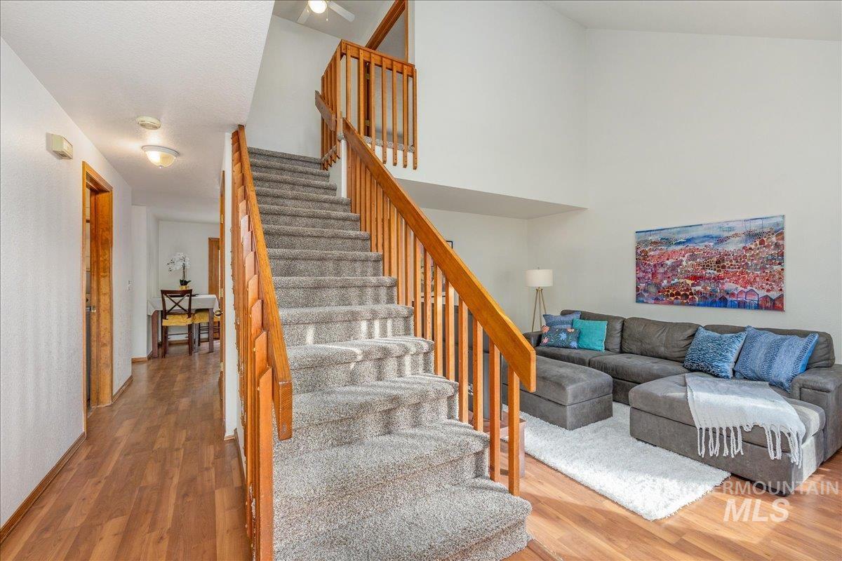 236 East Bayview Court Boise, ID 83706 - Photo 5 of 49 Staircase featuring wood finished floors and a high ceiling