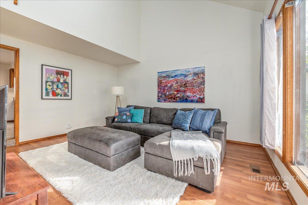 236 East Bayview Court Boise, ID 83706 - Photo 7 of 49 Living room with light wood-style flooring and a high ceiling