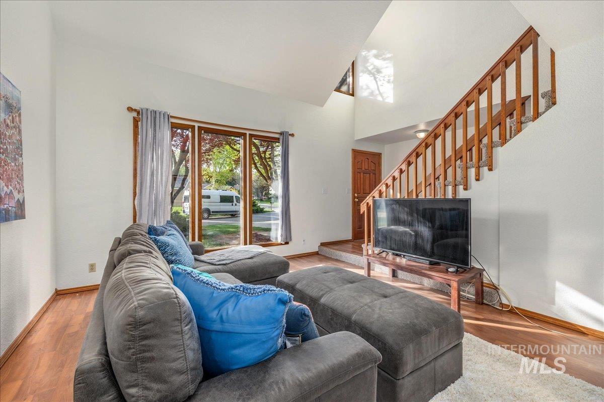 236 East Bayview Court Boise, ID 83706 - Photo 10 of 49 Living room featuring light wood-style floors and lofted ceiling