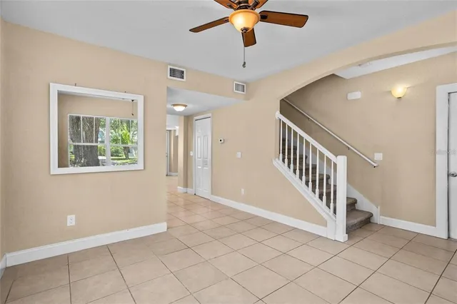 en view interior of a house with stairs and a ceiling fan