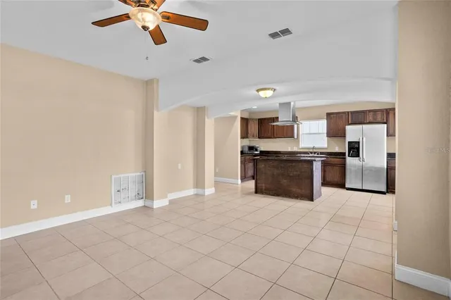 a large kitchen with stainless steel appliances a refrigerator and a sink