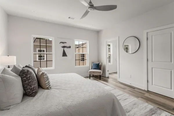 a bedroom with a large bed and a window