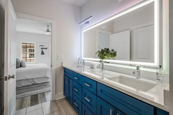 a bathroom with a double vanity sink and a mirror