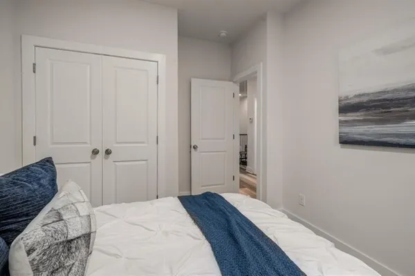 a bedroom with a bed and a rug