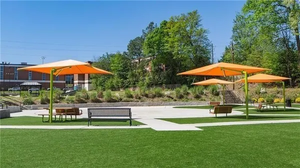 a swimming pool with outdoor seating yard and green space