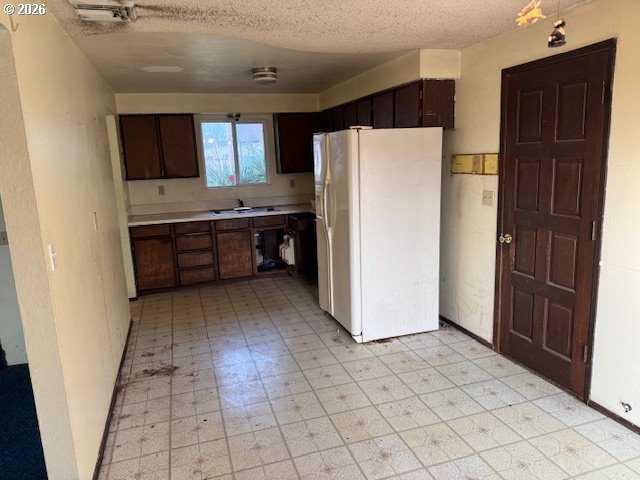 560 St John Street Sutherlin, OR 97479 - Photo 11 of 43 a kitchen with stainless steel appliances a refrigerator and a sink