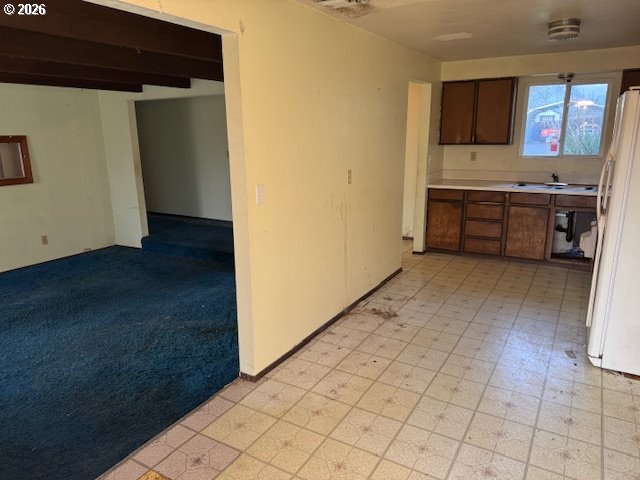 560 St John Street Sutherlin, OR 97479 - Photo 12 of 43 a view of a kitchen with a sink and a refrigerator