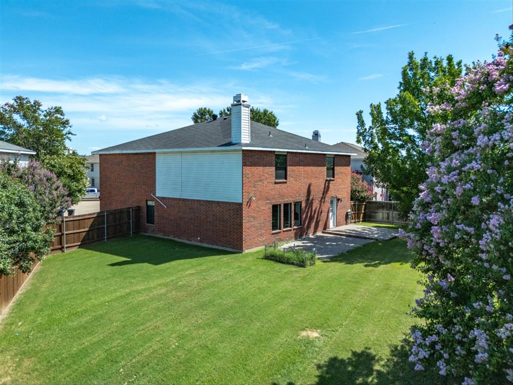 5304 Los Altos Road Fort Worth, TX 76244 - Photo 29 of 30 Back of house featuring brick siding, a fenced backyard, a patio, and a chimney