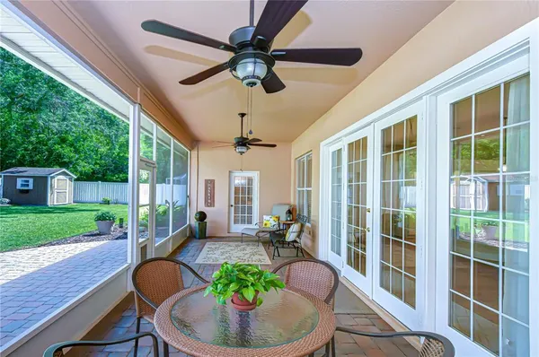 a view of a porch with furniture and a yard