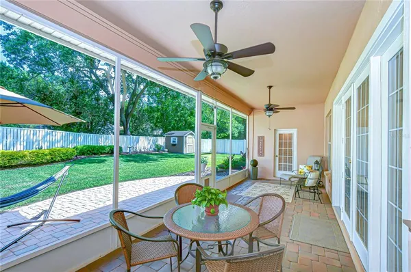 a view of a patio with a table chairs and a backyard