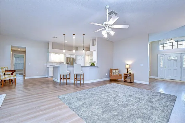 a living room with furniture and a chandelier