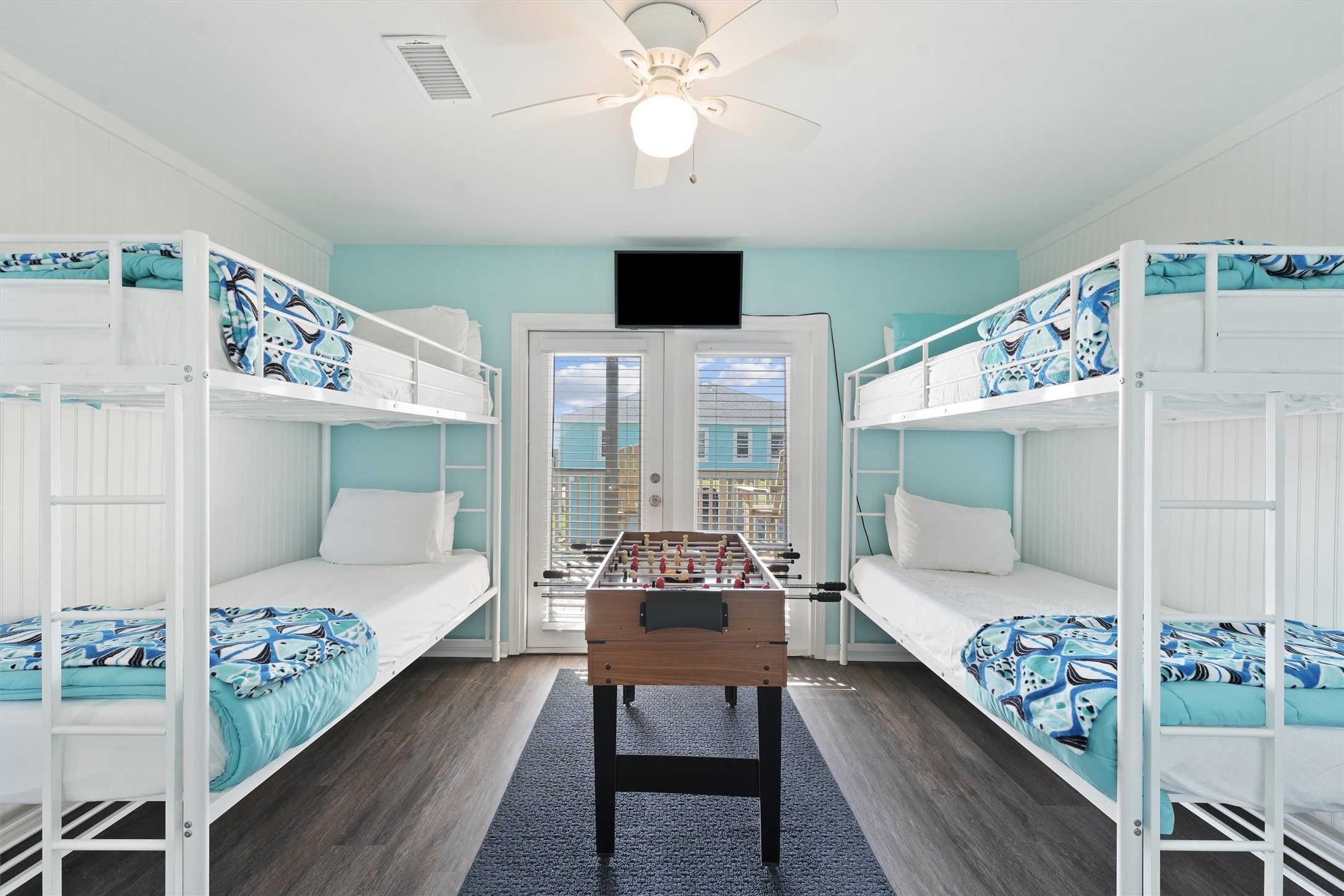 17607 Termini-San Luis Pass Road Galveston, TX 77554 - Photo 26 of 42 The bunk room offers direct access to the balcony, letting in natural light that brightens the whole space. It is a wonderful place for guests of all ages to relax and enjoy their stay.
