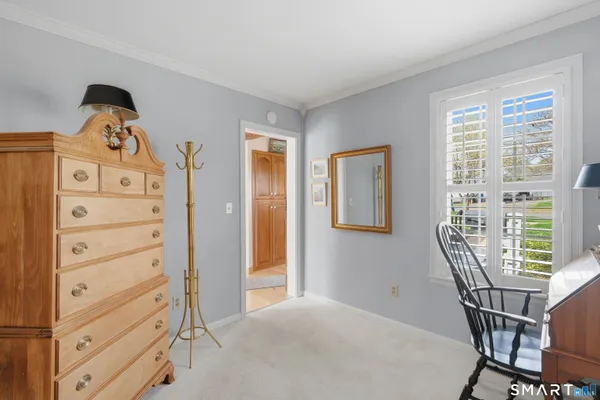 a view of a bedroom with furniture and wooden floor