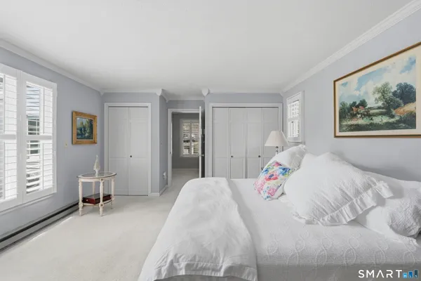a bedroom with a large bed and a window