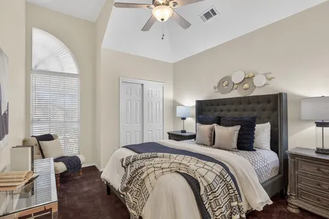 a bedroom with bed and window