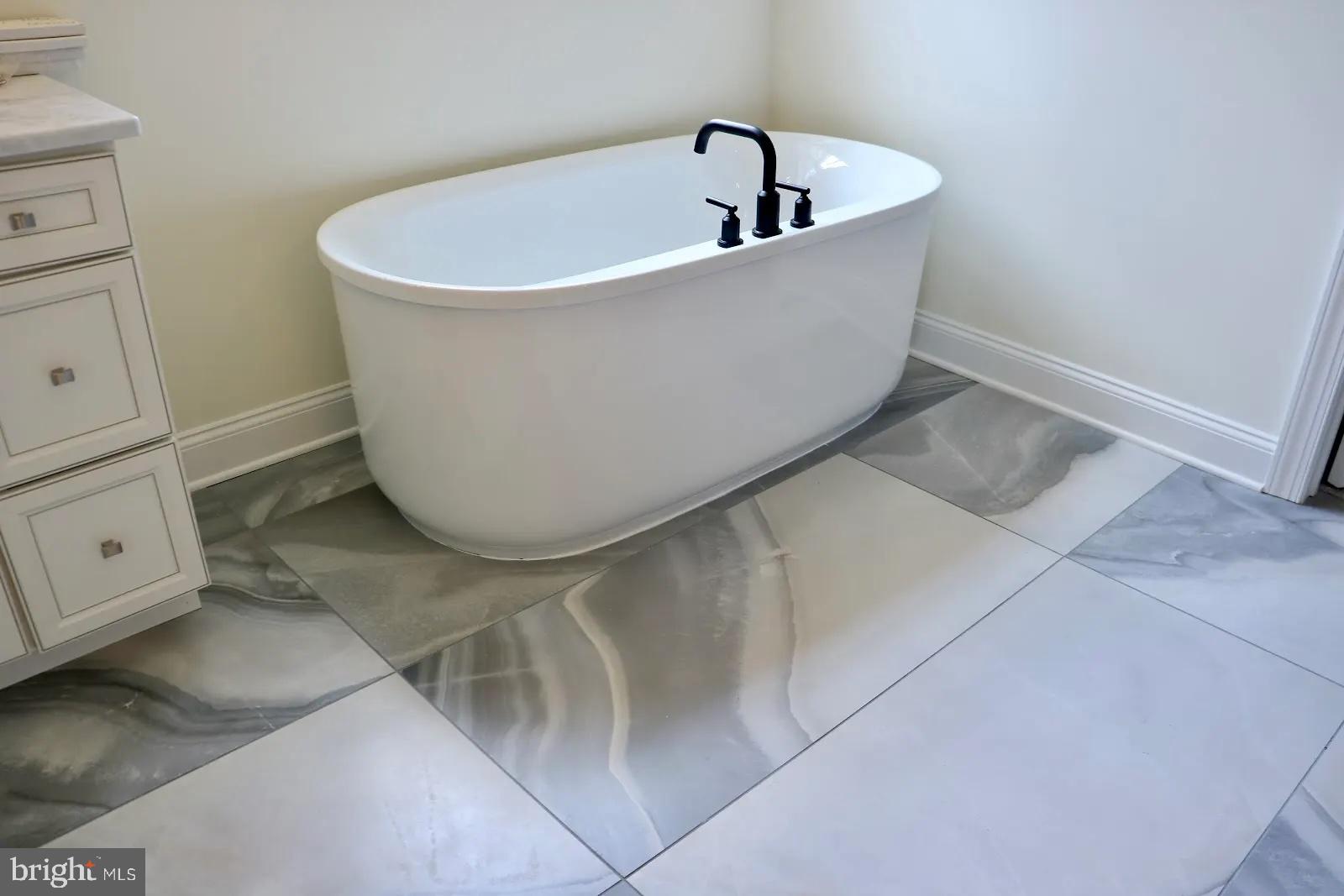 66 Kirk Road Garnet Valley, PA 19060 - Photo 18 of 37 a white tub sitting next to a white sink