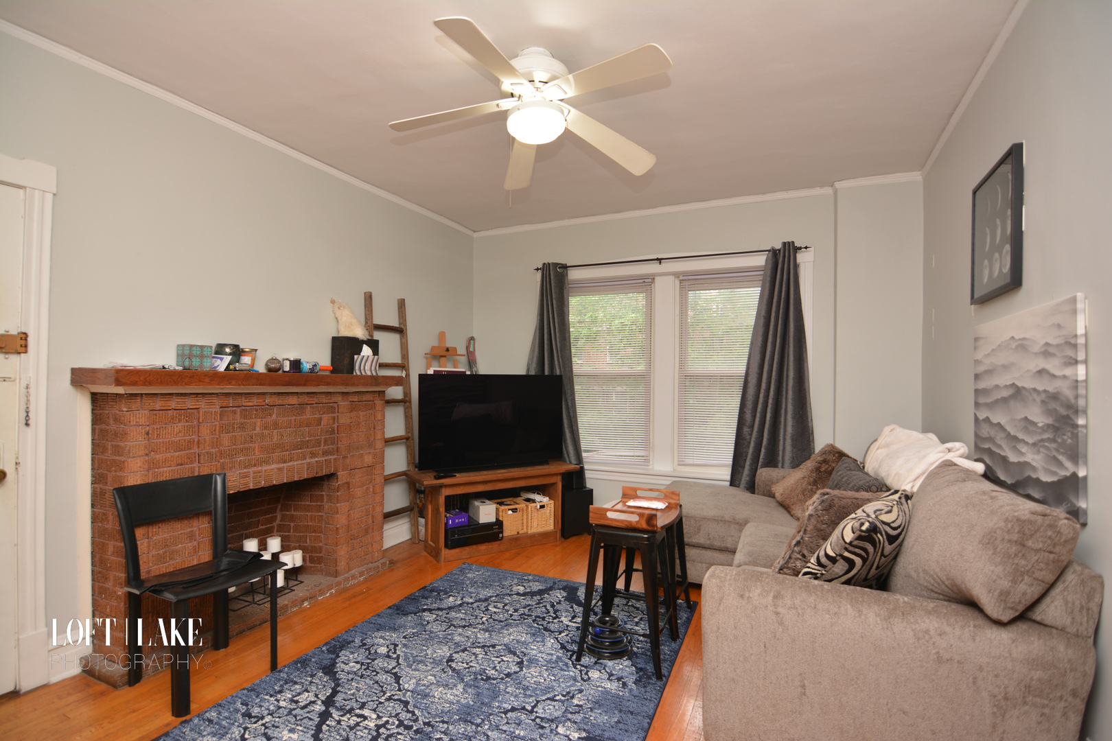 1609 West Grace Street, Unit 2 Chicago, IL 60613 - Photo 2 of 10 a living room with furniture a fireplace and a flat screen tv